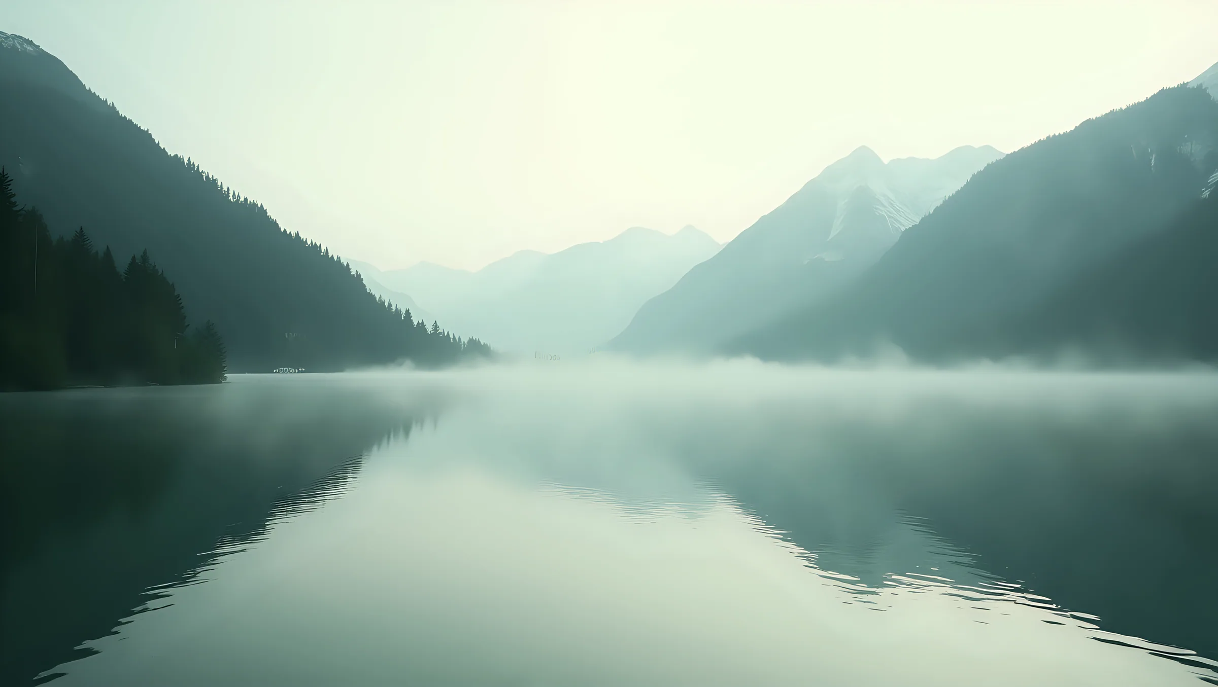 A desaturated, high-contrast photograph of still water, a mountain ridgeline, graded to the brand's forest and stone tones.